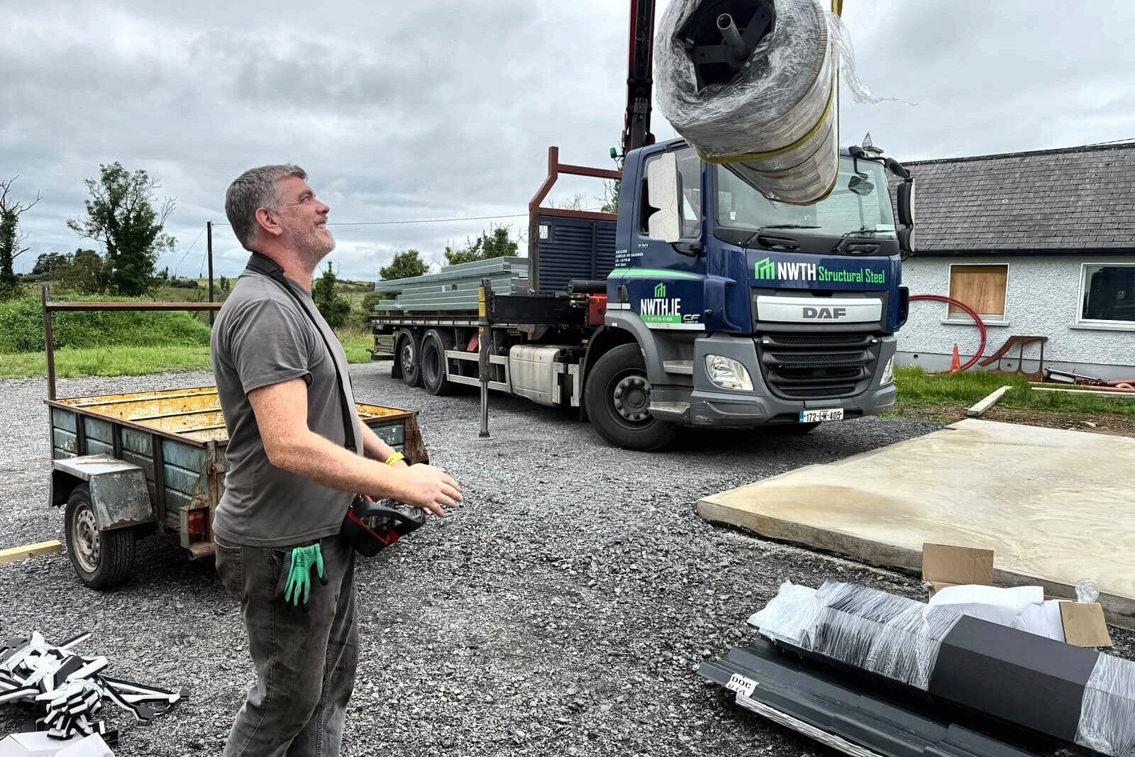 Unloading on site, with the concrete base ready beside the lorry